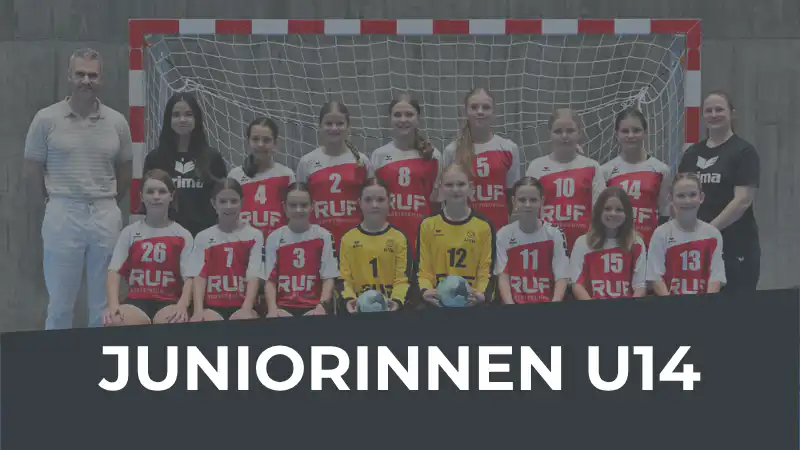 Group photo of a junior girls U14 handball team with two coaches in front of a goal; banner reads JUNIORINNEN U14 at the bottom edge.